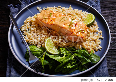 portion of cooked Salmon with rice and greens portion of cooked Salmon with rice and greens 87112360