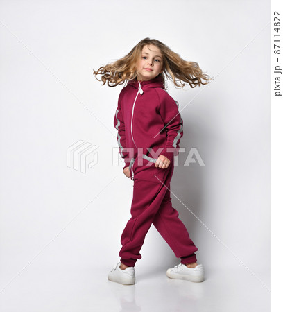 Happy stylish girl in a sports burgundy suit. a 87114822