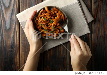 Concept of tasty eating with marinated mushrooms on wooden table, top view Concept of tasty eating with marinated mushrooms on wooden table, top view 87115145