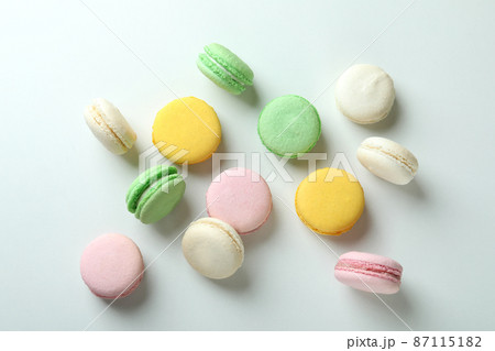 Concept of tasty dessert with macaroons on white background 87115182