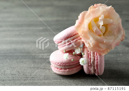 Concept of tasty dessert with macaroons on gray textured table 87115191