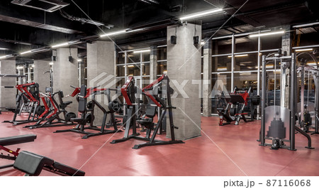 Strength equipment for body training in spacious, well lit, empty gym interior with huge windows. Modern exercise machines. Sport, fitness Strength equipment for body training in spacious, well lit, empty gym interior with huge windows. Modern exercise machines. Sport, fitness 87116068