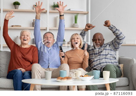 Happy multiracial elderly people watching football game on TV Happy multiracial elderly people watching football game on TV 87116093
