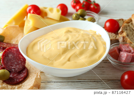 Concept of delicious food with fondue on white wooden table Concept of delicious food with fondue on white wooden table 87116427