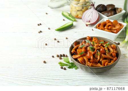 Concept of tasty food with marinated mushrooms on wooden table 87117668