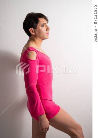 Homosexual in a pink female dress. A man in make-up. 87121855