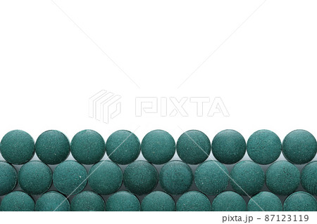 Spirulina tablets close up top view. Flat lay Healthy food supplement. Super food ingredient. top view place for text 87123119