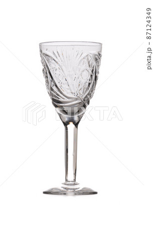 Inlaid glass for vodka on a high stem isolated on a white background. 87124349