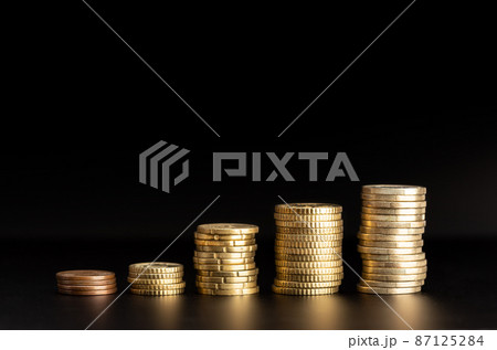 Rising Coin stacks on black background. Growth, income, savings concept. Copy space 87125284