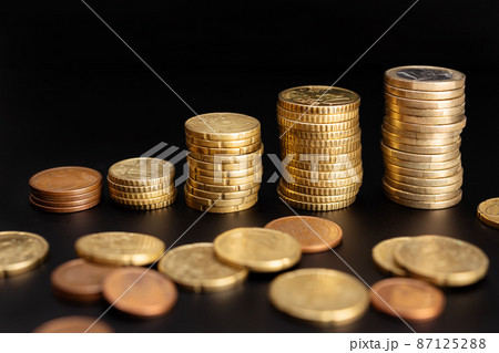 Rising euro Coin stacks on black background. Growth, income, savings concept. Copy space Rising euro Coin stacks on black background. Growth, income, savings concept. Copy space 87125288