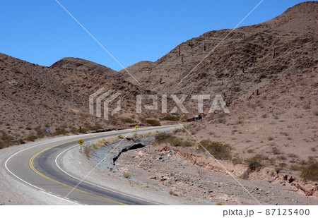 empty road on desert landscape, dry mountainous area, road trip empty road on desert landscape, dry mountainous area, road trip 87125400