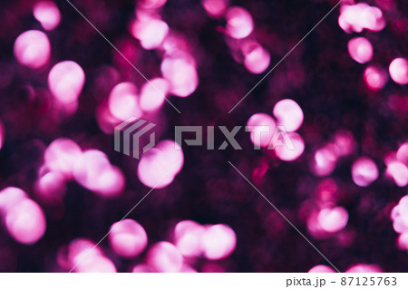 Neon bokeh light. Blur sparks. Festive glitz sparkles. Defocused pink color glow shiny sequin pattern on dark black abstract background. Neon bokeh light. Blur sparks. Festive glitz sparkles. Defocused pink color glow shiny sequin pattern on dark black abstract background. 87125763