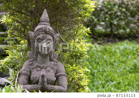 Old stone statue of a woman for garden decoration. Old stone statue of a woman for garden decoration. 87133113