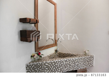 Interior of bathroom with sink basin faucet and mirror. Interior of bathroom with sink basin faucet and mirror. 87133163