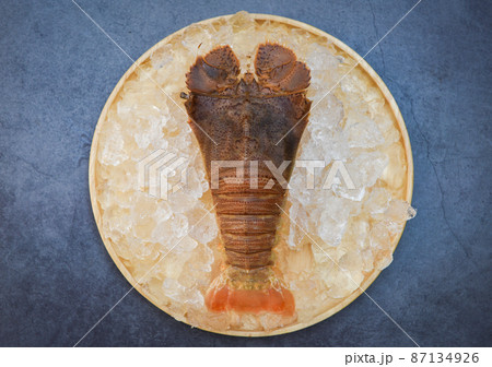 Raw flathead lobster shrimps on ice, fresh slipper lobster flathead for cooking on dark background in the seafood restaurant or seafood market, Rock Lobster Moreton Bay Bug Raw flathead lobster shrimps on ice, fresh slipper lobster flathead for cooking on dark background in the seafood restaurant or seafood market, Rock Lobster Moreton Bay Bug 87134926
