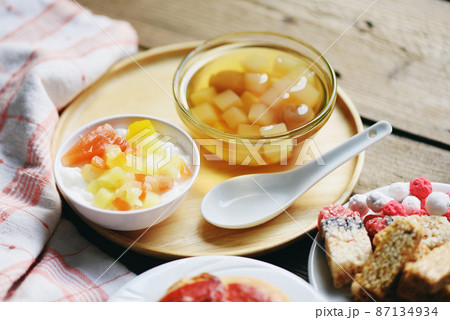 Chinese desserts, milk pudding fruit salad and Mix ginkgo nuts cassava syrup coconut jelly in longan juice on glass bowl, Thai and Chinese longan date soup Asian dessert sweets 87134934