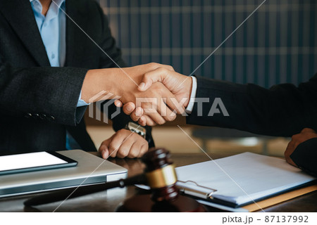 Justice and law concept.Male judge in a courtroom the gavel, working with digital tablet computer on wood table. 87137992