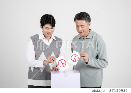 asian korean old and young two men voting in ballot box 87139985