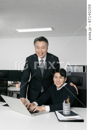 business concept asian korean old and young two men, different generations male man boss and employee concept, working with laptop 87140209
