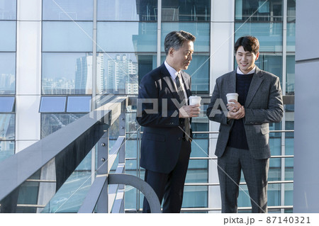 business concept asian korean old and young two men, different generations male man boss and employee concept, talking with coffee 87140321