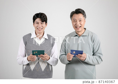 asian korean old and young two men holding a bankbook 87140367