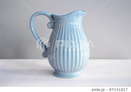 Beautiful textured blue jug for drinks close-up. Beautiful textured blue jug for drinks close-up. 87141827