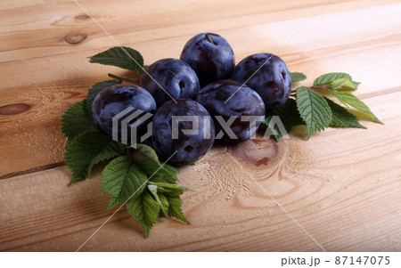 Plums on table 87147075
