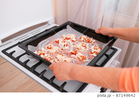 Chops. Woman hands put fresh turkey steaks meat on oven tray Chops. Woman hands put fresh turkey steaks meat on oven tray 87149642
