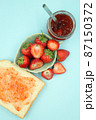 Top view of toast strawberries and jam on isolated pastel background 87150372
