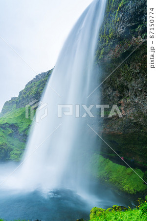 Natural landscape of beautiful Seljalandsfoss Waterfalls in summer cloudy day. Natural landscape of beautiful Seljalandsfoss Waterfalls in summer cloudy day. 87150774