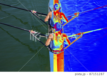 Real and Thermal image of two rowers in a boat, rowing on the tranquil lake Real and Thermal image of two rowers in a boat, rowing on the tranquil lake 87151287