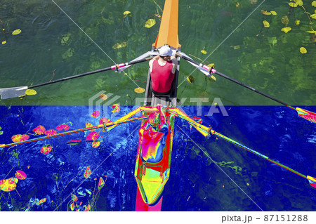 Real and Thermal image of two rowers in a boat, rowing on the tranquil lake 87151288