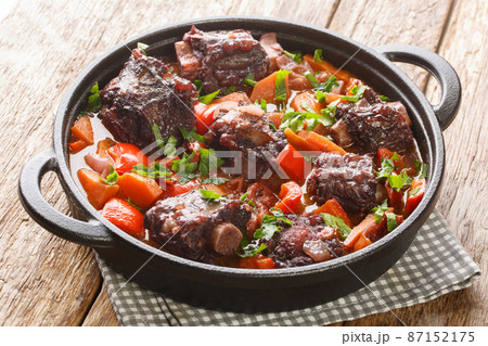 Traditional spanish dish slow cooked oxtail in red wine sauce with rabo de toro closeup on a pot on the table. Horizontal 87152175