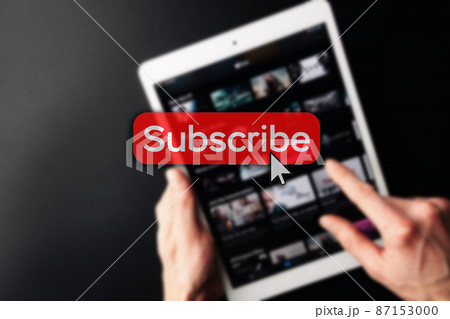 Subscription service. Online video red subscribe button. Internet service on laptop digital tablet blured technology background. Streaming video. Communication network. Subscription service. Online video red subscribe button. Internet service on laptop digital tablet blured technology background. Streaming video. Communication network. 87153000