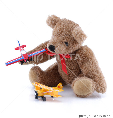 Small cute teddy playing with toy planes Small cute teddy playing with toy planes 87154077