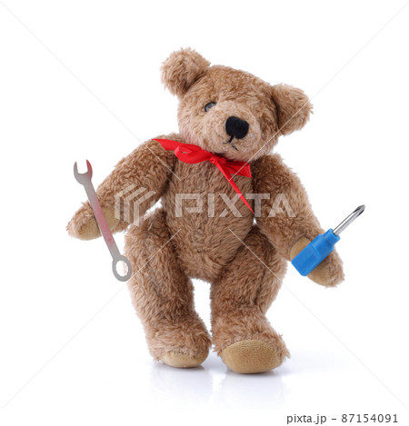 Handy Teddy bear with tools screwdriver spanner on white Handy Teddy bear with tools screwdriver spanner on white 87154091