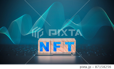 NFT word on wooden cube block which is placed on a laptop. NFT non fungible tokens concept. 87158256