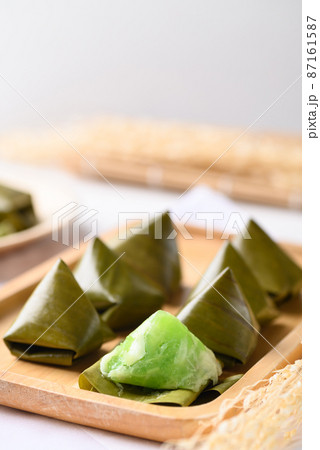 Thai dessert (Khanom Tian), Sweet dough pyramid stuffed with coconut wrapped by banana leaf 87161587