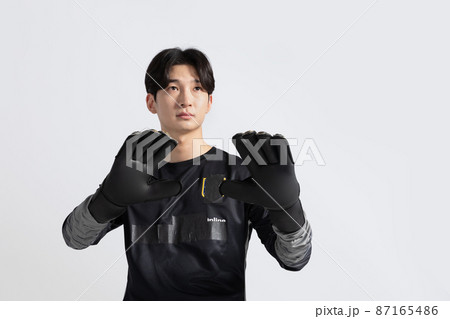 soccer football sports player, asian korean man with motions in studio background 87165486