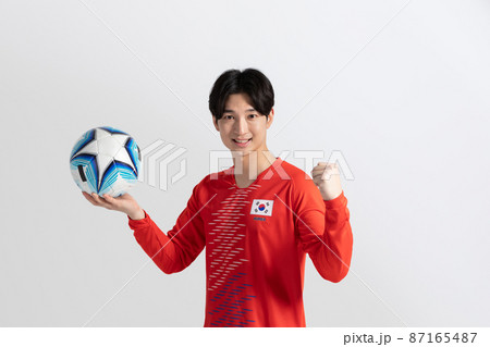 soccer football sports player, asian korean man with motions in studio background 87165487