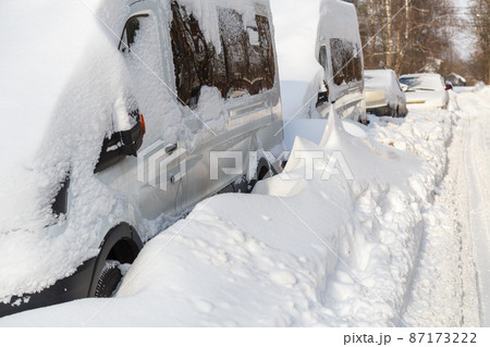 close-up view on snow-covered cars at sunny winter morning close-up view on snow-covered cars at sunny winter morning 87173222
