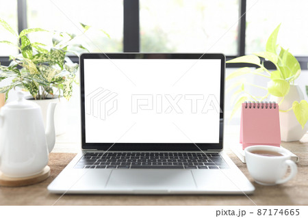 Laptop and coffee cup and mini calendar Laptop and coffee cup and mini calendar 87174665