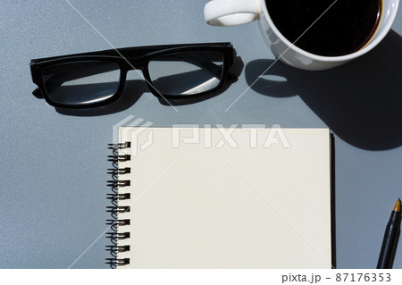 Notepad with notepad, potted plant, pen and glasses. Flat lay. 87176353