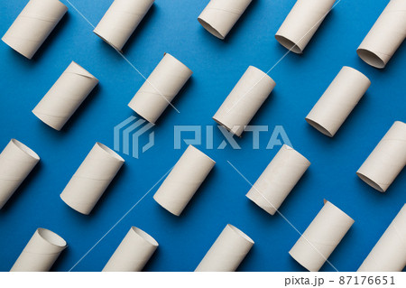 Empty toilet paper roll on colored background. Recyclable paper tube with metal plug end made of kraft paper or cardboard 87176651