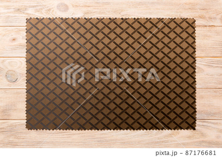 Top view of brown tablecloth for food on wooden background. Empty space for your design 87176681