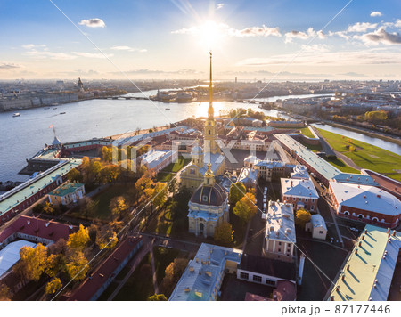 Russia, St. Petersburg, Aerial landscape of Peter and Paul cathedral at sunset, walls of fortress, Golden autumn, panorama landscape, golden spire with cross and angel, drawbridges, river Neva 87177446