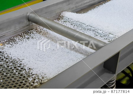 Recycled plastic granules on automatic conveyor belt, shale shaker Recycled plastic granules on automatic conveyor belt, shale shaker 87177814