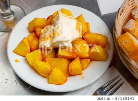 Spanish dish Patatas bravas with hot sauce 87180145