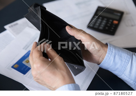 Close up view old woman opening empty wallet. Close up view old woman opening empty wallet. 87180527