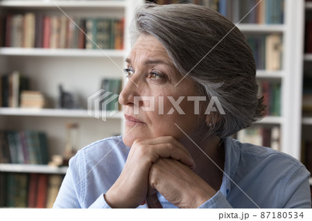 Head shot thoughtful middle aged woman looking in distance. Head shot thoughtful middle aged woman looking in distance. 87180534